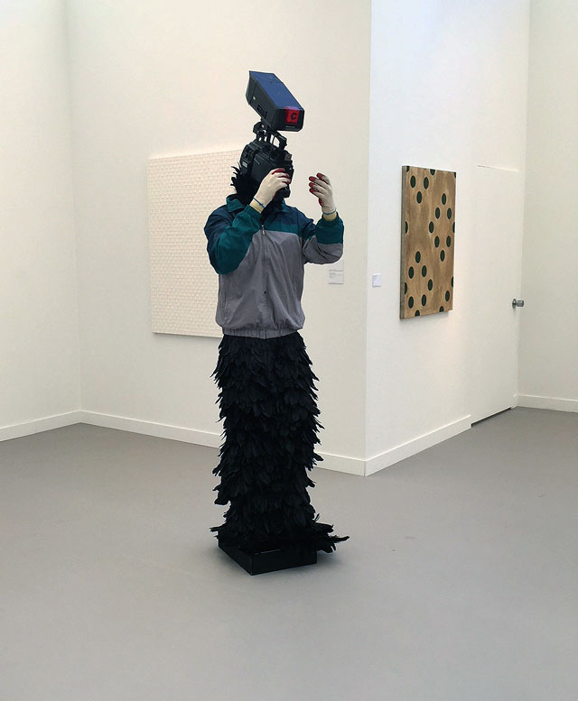 Minouk Lim. L'homme à la caméra, 2015. FRP mannequin, windbreaker, gloves, feathers, broadcast camera. Photograph: Jill Spalding.