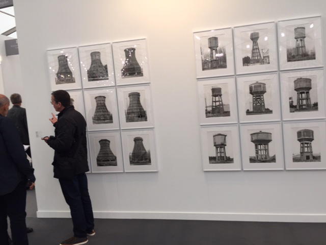 Bernd + Hilla Becher. (Left) Cooling Towers, 1969-92. Nine silver-gelatin prints, each 40 x 30 cm; (Right) Water Towers, 1967-80. Nine silver-gelatin prints, each 40 x 30 cm. Sprüth Magers. Photograph: Jill Spalding.