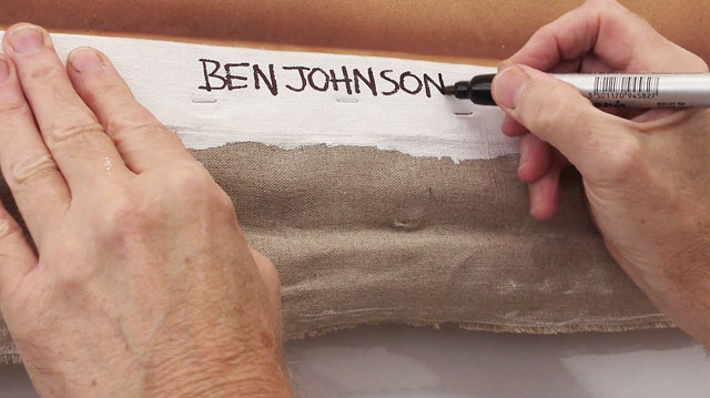 Ben Johnson signing the back of his painting Patio de los Arrayanes, September 2015. Photograph: Martin Kennedy.