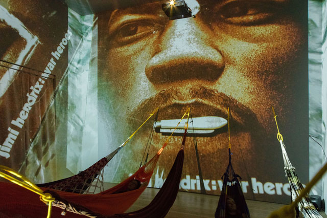 Hélio Oiticica. Installation view.  CC5 Hendrix-War, 1973. Thirty-three 35mm colour slides transferred to digital slideshow, sound, and hammocks. Site Specific Collections of César and Claudio Oiticica and Neville D’Almeida. Whitney Museum of American Art, New York, N.Y. Photograph by Oto Gillen.